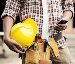 Man working with hard hat and cell phone